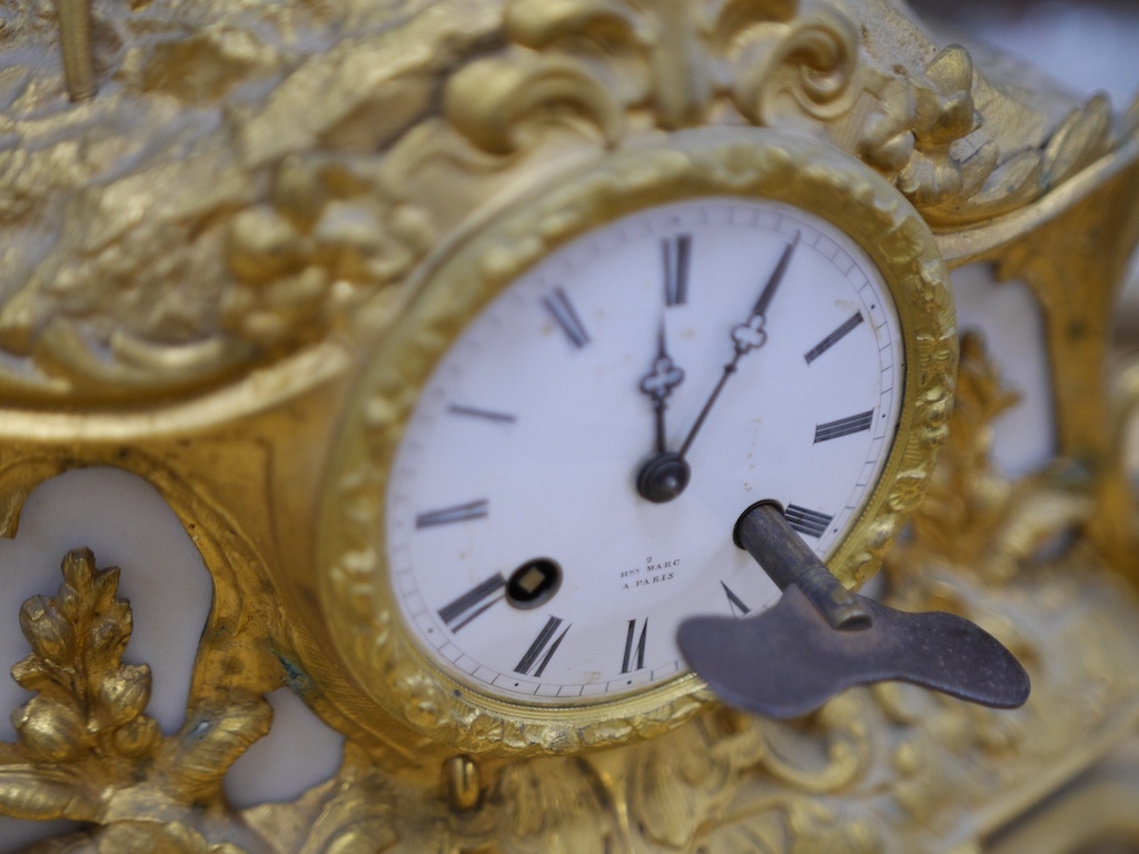 A 19th century French gilt spelter eight day mantel clock with surmount of a lady, with key, no pendulum, 41cm. Condition - fair to good, not tested